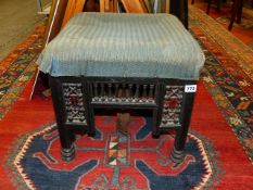 A SMALL AESTHETIC STOOL IN THE MANNER OF LIBERTYS. W.41cms.