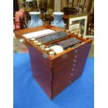 A MID 20th.C.MAHOGANY CASED DENTIST CABINET WITH RISING LID AND SIX GRADUATED DRAWERS ALL FULLY