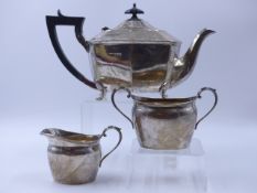 A SILVER THREE PIECE TEA SET COMPRISING OF AN ART DECO TEAPOT DATED 1930 TOGETHER WITH A CREAMER AND