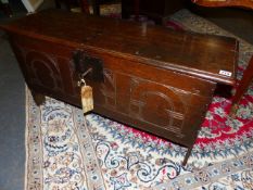 A SMALL 17th.C.OAK PLANK COFFER WITH SIMPLE CARVED DECORATION TO FRONT WITH PERIOD LOCK AND KEY. W.