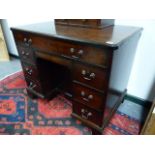 A GEO.III.MAHOGANY KNEEHOLE WRITING DESK WITH LONG FRIEZE DRAWER OVER SIX SIDE DRAWERS AND CENTRAL