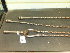 A SET OF THREE EARLY 19th.C.STEEL FIRESIDE IMPLEMENTS WITH TWIST SHAFTS, THE POKER L.73cms.