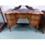 A CONTINENTAL WALNUT AND INLAID BRASS MOUNTED WRITING TABLE ON SHAPED CABRIOLE LEGS. W.115 x H.
