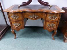 A CONTINENTAL WALNUT AND INLAID BRASS MOUNTED WRITING TABLE ON SHAPED CABRIOLE LEGS. W.115 x H.