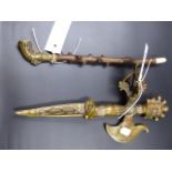 A TIBETAN BRASS PHURBA WITH FIGURAL AND STYLISED DECORATION L.34cms TOGETHER WITH A BRASS AND