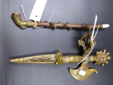 A TIBETAN BRASS PHURBA WITH FIGURAL AND STYLISED DECORATION L.34cms TOGETHER WITH A BRASS AND