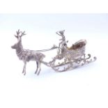 A CONTINENTAL SILVER MODEL OF A REINDEER PULLING A SLED SURMOUNTED BY A PUTTO. MEASUREMENTS 16cms