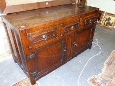 A 17th.C.AND LATER OAK SMALL DRESSER BASE WITH THREE FRIEZE DRAWERS OVER PANELLED DOORS. W.131 x H.