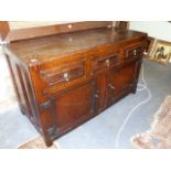 A 17th.C.AND LATER OAK SMALL DRESSER BASE WITH THREE FRIEZE DRAWERS OVER PANELLED DOORS. W.131 x H.