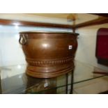 A LARGE 19th.C.COPPER JARDINIERE OR FOOTBATH WITH TIN WASHED INTERIOR AND CARRYING HANDLES. W.