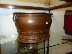 A LARGE 19th.C.COPPER JARDINIERE OR FOOTBATH WITH TIN WASHED INTERIOR AND CARRYING HANDLES. W.