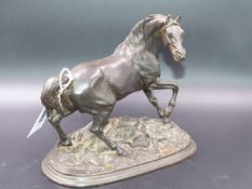 AN ANTIQUE WELL MODELLED FIGURE OF A STALLION ON A NATURALISTIC PLINTH BASE.