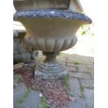 A CLASSICAL STYLE GARDEN URN RAISED ON TALL SQUARE PLINTH.