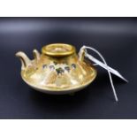 A MINIATURE JAPANESE SATSUMA TEAPOT WITH FIGURAL DECORATION SIGNED WITH CHARACTERS TO BASE. H.5cms.