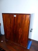 A LATE GEORGIAN MAHOGANY AND BOXWOOD INLAID TWO DOOR TABLE CABINET WITH SIDE CARRYING HANDLES. W.