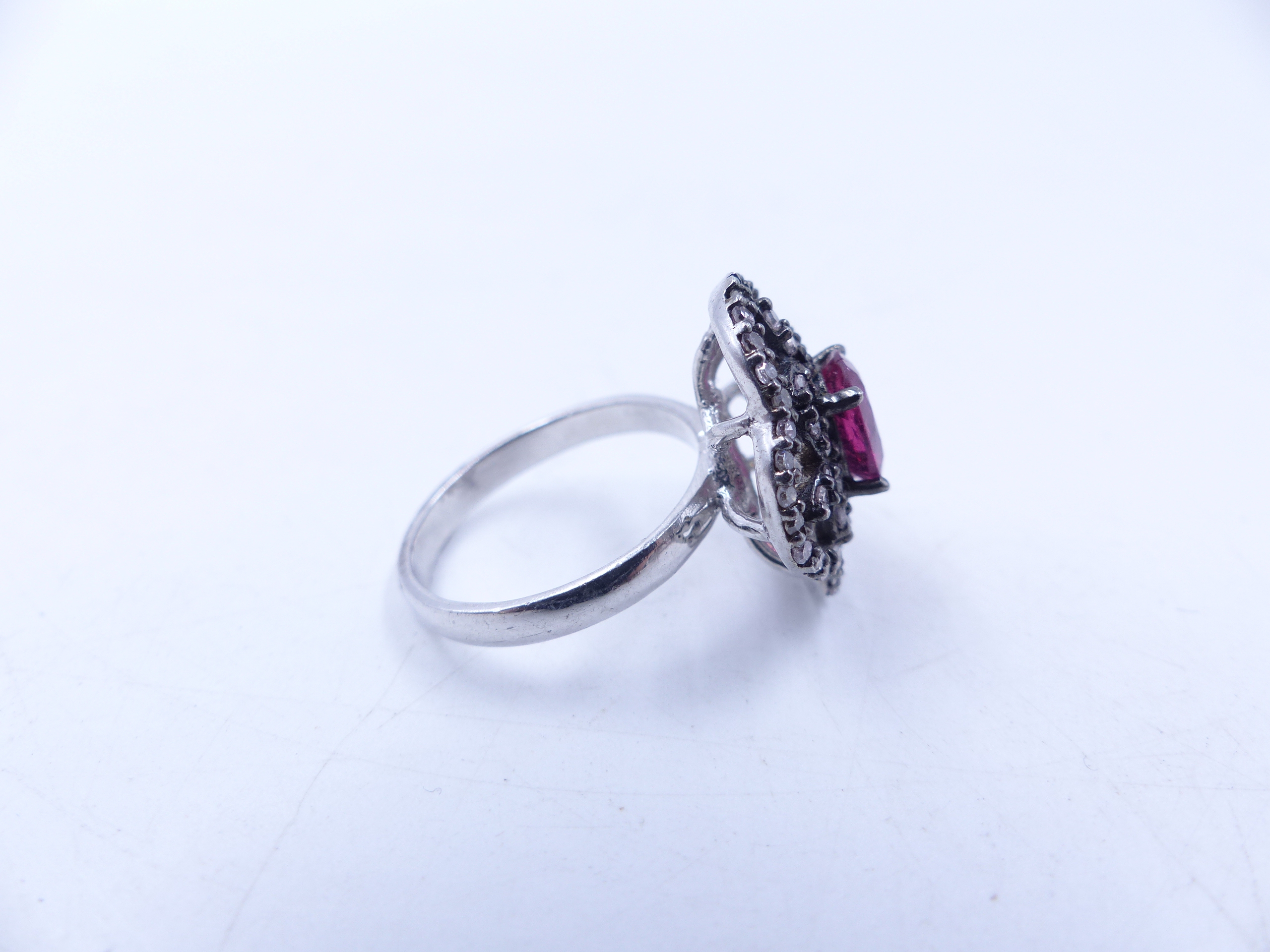 A PINK TOURMALINE AND DIAMOND OPEN WORK FILIGREE RING SET IN A WHITE METAL MOUNT,THE CENTRAL PINK - Image 8 of 17