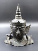 AN ASIAN BRONZE HEAD OF A DEITY WITH STYLISED FEATURES AND A KNOP HEAD DRESS. H.22cms.