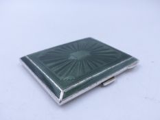 A GEORGE V GREEN GUILOCHE ENAMEL RECTANGULAR CIGARETTE CASE WITH A GILDED INNER. DATED 1933,