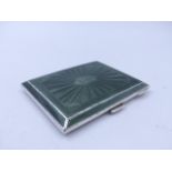 A GEORGE V GREEN GUILOCHE ENAMEL RECTANGULAR CIGARETTE CASE WITH A GILDED INNER. DATED 1933,