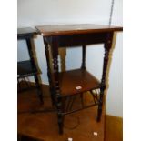 A LATE VICTORIAN ARTS AND CRAFTS MAHOGANY AND INLAID TWO TIER OCCASIONAL TABLE IN THE MANNER OF
