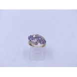 A 9ct YELLOW GOLD DIAMOND AND LAVENDER GEMSTONE DRESS RING. FINGER SIZE J, WEIGHT 2.4grms.