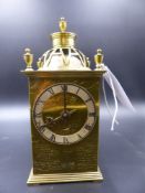 AN ARTS AND CRAFTS STYLE BRASS CASED DESK CLOCK WITH ENGRAVED DECORATION.