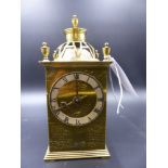 AN ARTS AND CRAFTS STYLE BRASS CASED DESK CLOCK WITH ENGRAVED DECORATION.