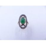 A YELLOW METAL (TESTS AS GOLD) DIAMOND AND CABOCHON GEMSTONE OVAL ELONGATED RING. FINGER SIZE O,