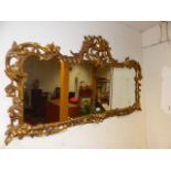 A 19th.C.CARVED GILTWOOD WALL MIRROR. W.133 x H.71cms.