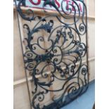 A VICTORIAN WROUGHT IRON WINDOW GRILLE WITH LEAF DECORATION.