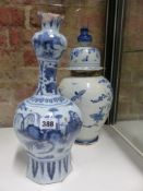 A CONTINENTAL DELFT POTTERY VASE WITH ELONGATED NECK DEPICTING AN ORIENTAL PAINTED SCENE. H.38cms