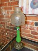 A LATE VICTORIAN CANDLE STAND WITH CAST BRASS BASE, GREEN GLASS STEM AND ETCHED GLASS SHADE LABELLED