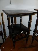 AN ARTS AND CRAFTS EBONISED TWO TIER OCCASIONAL TABLE IN THE MANNER OF GODWIN.