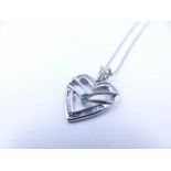 A 9ct WHITE GOLD DIAMOND AND EMERALD HEART PENDANT SUSPENDED ON A WHITE GOLD FANCY LINK SOLID 40cm