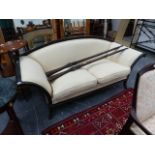 A REGENCY STYLE TWO SEATER SETTEE WITH SWEPT ARMS.