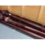 A QTY OF WOODEN CURTAIN POLES.