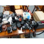 A QTY OF CAMERAS, LENSES AND ACCESSORIES.