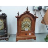 A WALNUT MANTLE CLOCK.