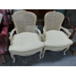 A PAIR OF FRENCH STYLE BERGERE ARMCHAIRS.