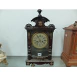 AN EBONISED MANTLE CLOCK.