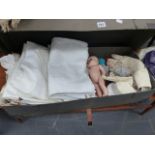 A BOX OF LINENS AND DOLLS.