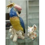 A PORCELAIN FIGURE OF A PARROT AND A WEDGEWOOD ELEPHANT.