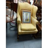 A LARGE WING BACK ARMCHAIR.