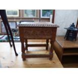 A CARVED OAK BOX STOOL.