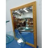 A GILT FRAMED MIRROR.