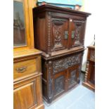 AN INTERESTING JACOBEAN STYLE CARVED OAK CABINET.