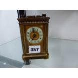 A BRASS CARRIAGE CLOCK COMPLETE WITH KEY.