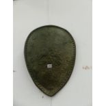 A RELIEF DECORATED SHIELD AFTER THE ANTIQUE.