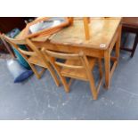 A DOUBLE CHILD'S SCHOOL DESK AND CHAIRS.