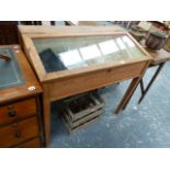 A GLAZED PINE DISPLAY CABINET.